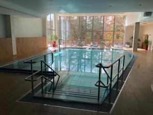 ein großer Pool mit Stühlen in einem Gebäude in der Unterkunft Hotel U Zámečku Cihelny in Karlsbad