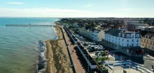 een luchtzicht op een strand met een pier bij Beau Rivage Hôtel-Restaurant in Luc-sur-Mer