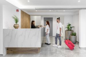 a group of people standing in an office at Anassa Suites in Leptokaria