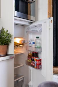 an open refrigerator with food and drinks in it at Cosy Nock ! Little Gem at City Center with Large Terrace ! in Breda