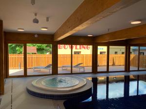 einem Pool mit Badewanne in der Mitte eines Gebäudes in der Unterkunft Apartmany Arber in Železná Ruda