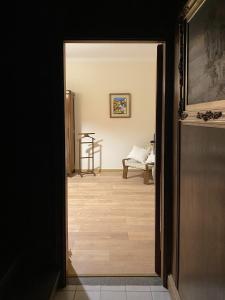 an open door to a living room with a wooden floor at Villa Viuli in Torre del Greco