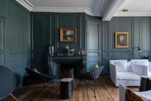 a living room with a couch and a fireplace at La Maison Pavie in Dinan