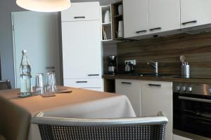 cocina con mesa, fregadero y fogones en NewPort Weser, NewPort Marina, en Bremerhaven