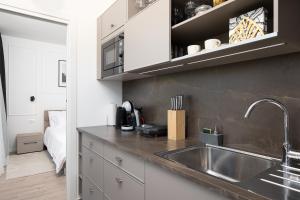 a kitchen with a sink and a counter top at Golden Gate apartment in Pula