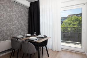 a dining room with a table and a large window at Golden Gate apartment in Pula