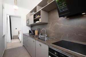 a kitchen with a sink and a counter top at Golden Gate apartment in Pula