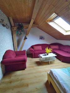 a living room with red couches and a table at Apartmán v Srní in Srní