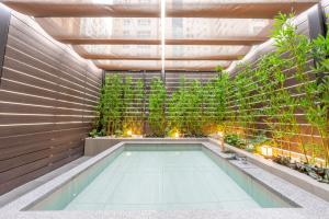 an indoor pool with plants in a building at Hotel Foret The Spa in Busan