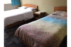 Una cama o camas en una habitación de Madani Muslim Hotel