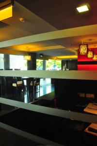 a view of a restaurant with tables and chairs at Tat Place Hotel in Kuala Belait