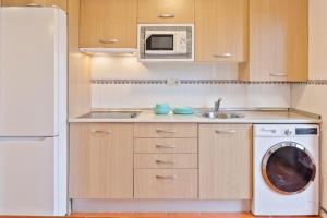 A kitchen or kitchenette at Abba Comillas Apartments