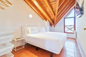 A bed or beds in a room at Abba Comillas Apartments