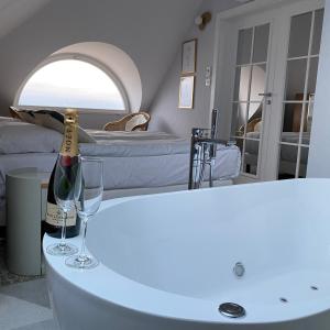 - une chambre avec une bouteille de vin et deux verres sur une table dans l'établissement Hotel Zhong Hua, à Sopot