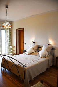 a bedroom with a large bed with white sheets and pillows at Villa Viuli in Torre del Greco