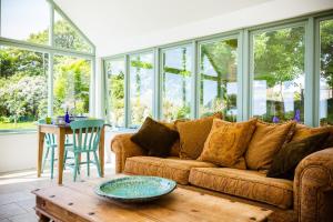 a living room with a couch and a table at Fig Tree House in Penryn