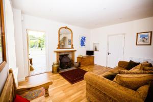 a living room with a couch and a fireplace at Fig Tree House in Penryn