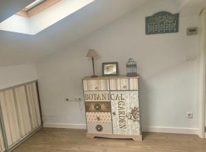 a room with a white wall and a wooden cabinet at Precioso apartamento castro Urdiales in Castro-Urdiales