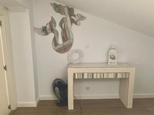 a room with a table with shoes on the wall at Precioso apartamento castro Urdiales in Castro-Urdiales