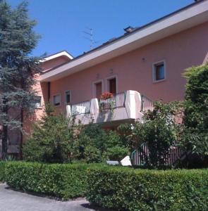 a house with a balcony on the side of it at B&C Apartments in Lido di Jesolo