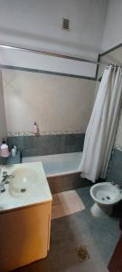 a bathroom with a sink and a toilet at Casa de La Lila in Salta