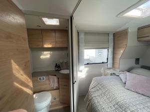 um pequeno quarto com uma cama e um WC em Autocamper Tórshavn em Tórshavn