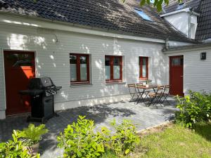 un patio con parrilla, mesa y sillas en Apartments Kassebohmer Weg, en Rostock