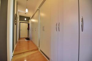 a hallway with white closets and a hallway with a hallway at Central Park Gallery in Sarajevo