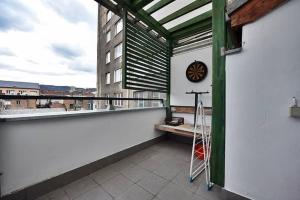 a balcony with a cross and a bench on a building at Central Park Gallery in Sarajevo