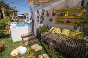 a backyard with a couch and a swimming pool at Beach House Babylon guest house with kitchenette and garden in Torreira