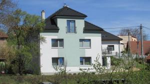 a white house with a black roof at apartmány LUHA in Luhačovice