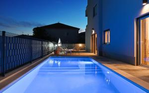 a swimming pool in the backyard of a house at Luxury Apartment Maravic with Private Pool in Trogir