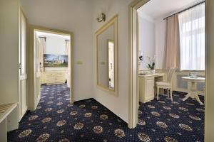 a corridor of a hotel room with a mirror at Hotel Podhrad in Hluboká nad Vltavou