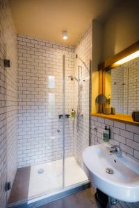 a bathroom with a tub and a sink and a shower at Hotel Luis in Regensburg