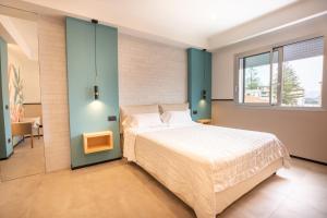 Krevet ili kreveti u jedinici u okviru objekta Antares Rooms and Suites