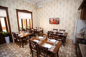 a dining room with wooden tables and chairs at Guest House Diyor Gold in Samarkand