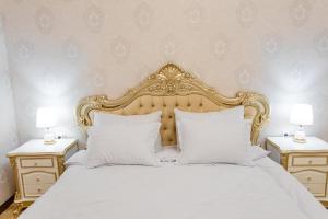 a bedroom with a white bed with white pillows at Guest House Diyor Gold in Samarkand