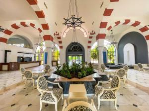 a lobby with chairs and tables and windows at Club Beyy Resort Hotel - Ultra All Inclusive in Izmir