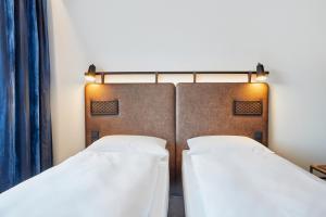 Кровать или кровати в номере H2 Hotel Düsseldorf City