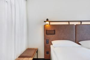 Кровать или кровати в номере H2 Hotel Düsseldorf City