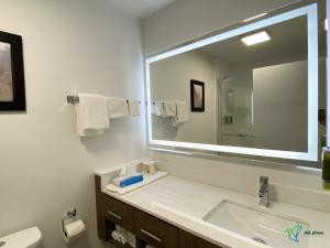 a bathroom with a sink and a large mirror at Glengarry Extended Stays in Truro