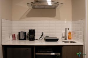 a kitchen with a counter top with a sink at Glengarry Extended Stays in Truro