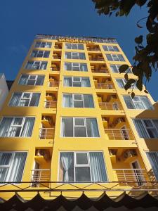 un edificio giallo con balconi sopra di VANDA Hotel Nha Trang a Nha Trang