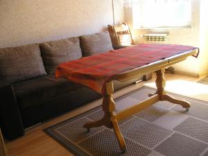 a coffee table in a living room with a couch at Pokoje Centrum U Ani in Augustów