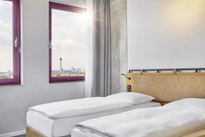 Krevet ili kreveti u jedinici u objektu H2 Hotel Düsseldorf Seestern