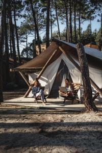 two people sitting in front of a tent at Bukubaki Eco Surf in Ferrel