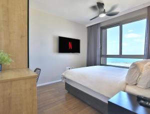 Uma TV ou centro de entretenimento em Luxury Suites by Notaly Ariel - Carmel Beach