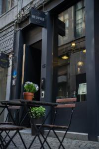 a table and chairs in front of a building at Hotel Neuvice in Liège