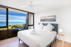 Tempat tidur dalam kamar di Azure Absolute Beachfront I Pet Friendly