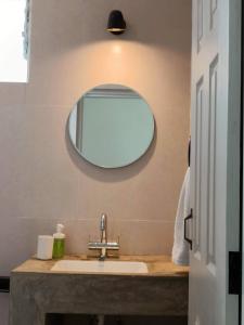 a bathroom with a sink and a mirror at Beseco Bed and Breakfast in Benaulim